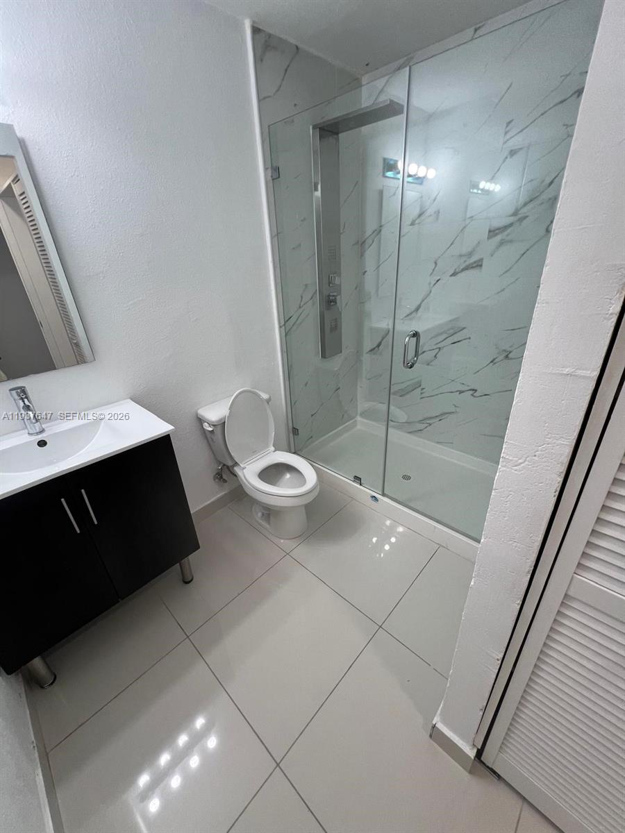 13937 Southwest 259th Street Homestead, FL 33032 - Photo 12 of 17 a bathroom with a double vanity sink toilet and shower