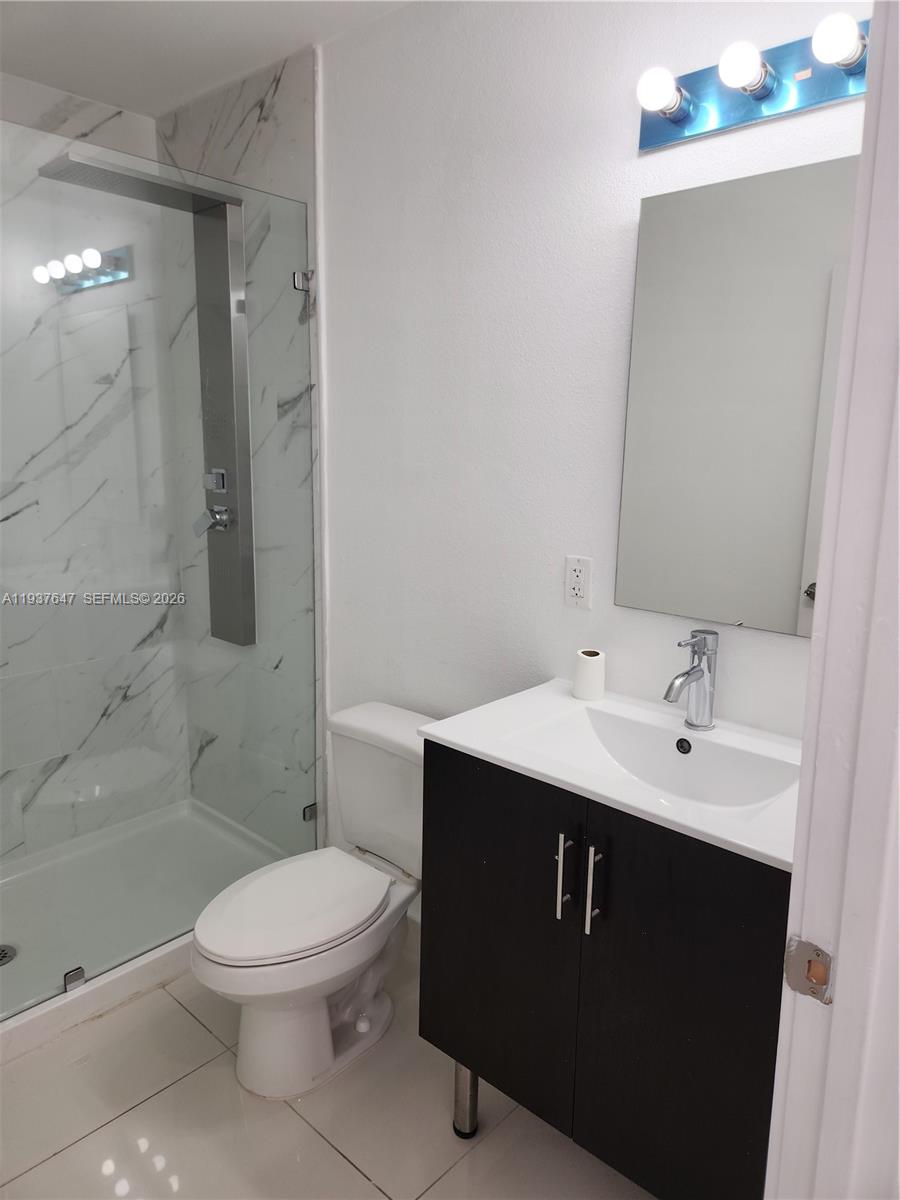 13937 Southwest 259th Street Homestead, FL 33032 - Photo 13 of 17 a bathroom with a sink a toilet and shower