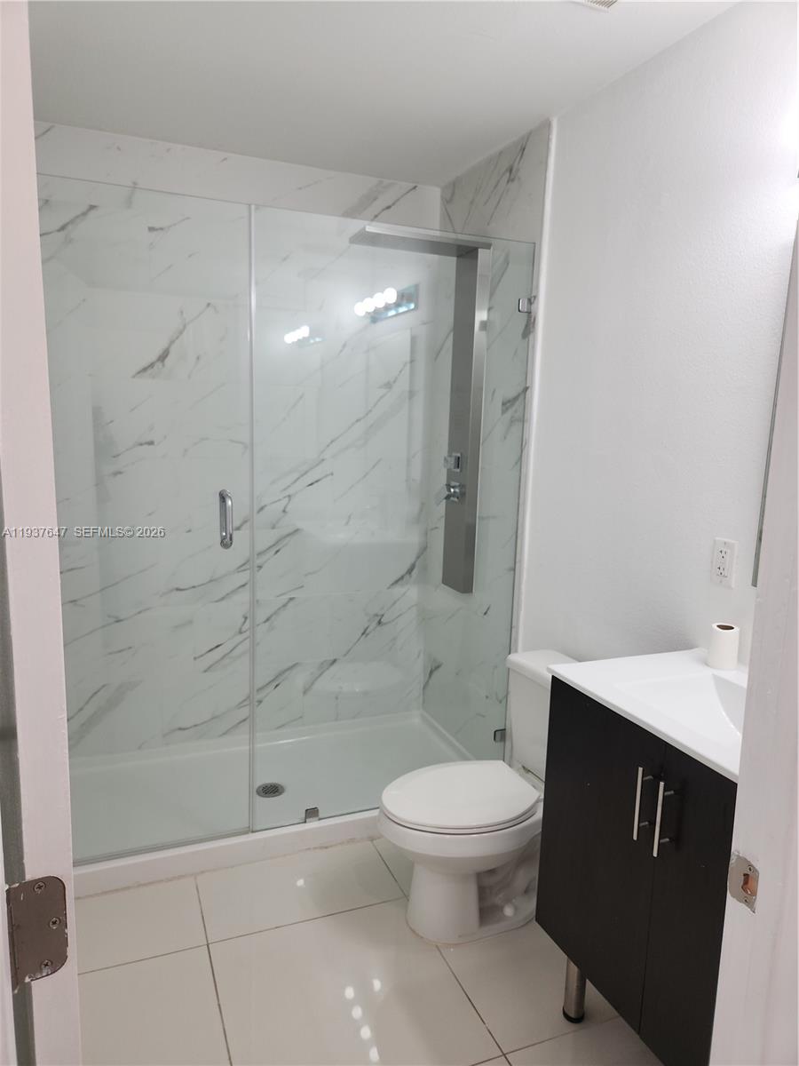 13937 Southwest 259th Street Homestead, FL 33032 - Photo 14 of 17 a white toilet sitting next to a bathroom sink