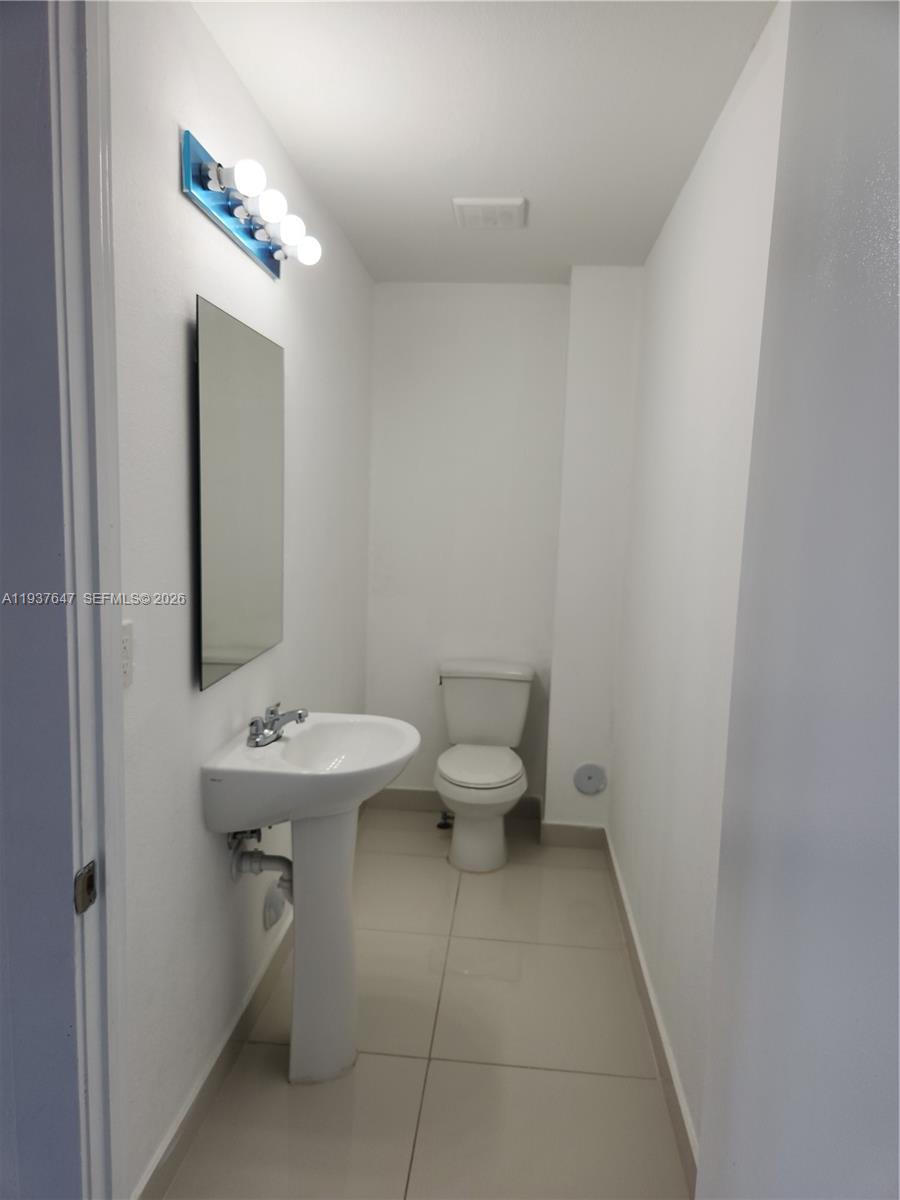13937 Southwest 259th Street Homestead, FL 33032 - Photo 15 of 17 a bathroom with a sink toilet and mirror