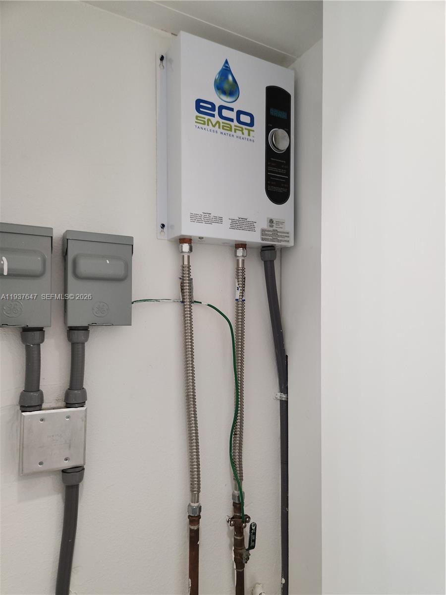 13937 Southwest 259th Street Homestead, FL 33032 - Photo 16 of 17 a close view of a utility room with dryer and washer