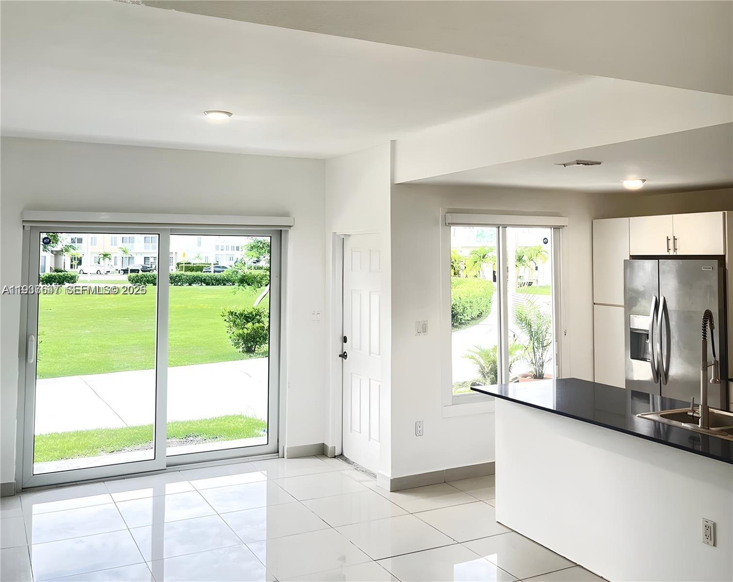 13937 Southwest 259th Street Homestead, FL 33032 - Photo 3 of 17 a view of a kitchen with a large window