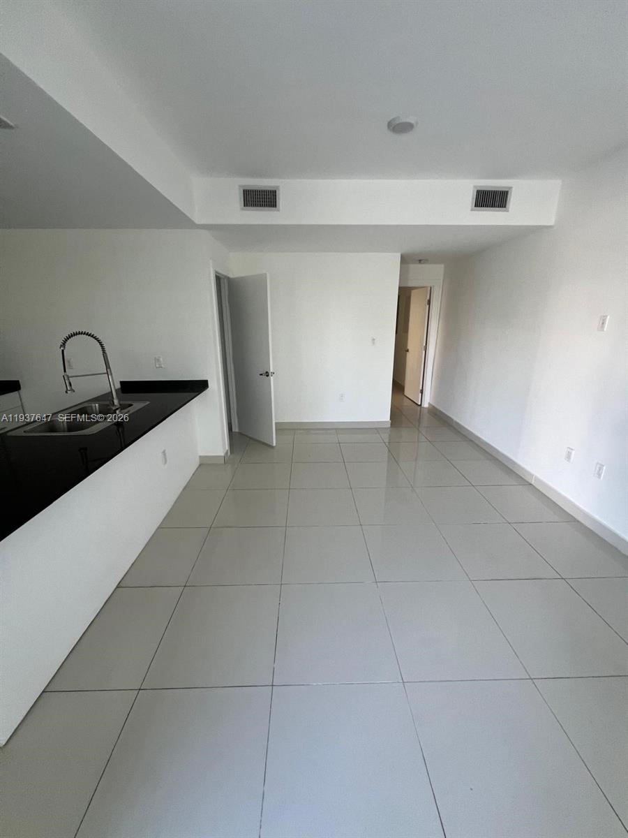 13937 Southwest 259th Street Homestead, FL 33032 - Photo 5 of 17 a kitchen with granite countertop a sink and cabinets