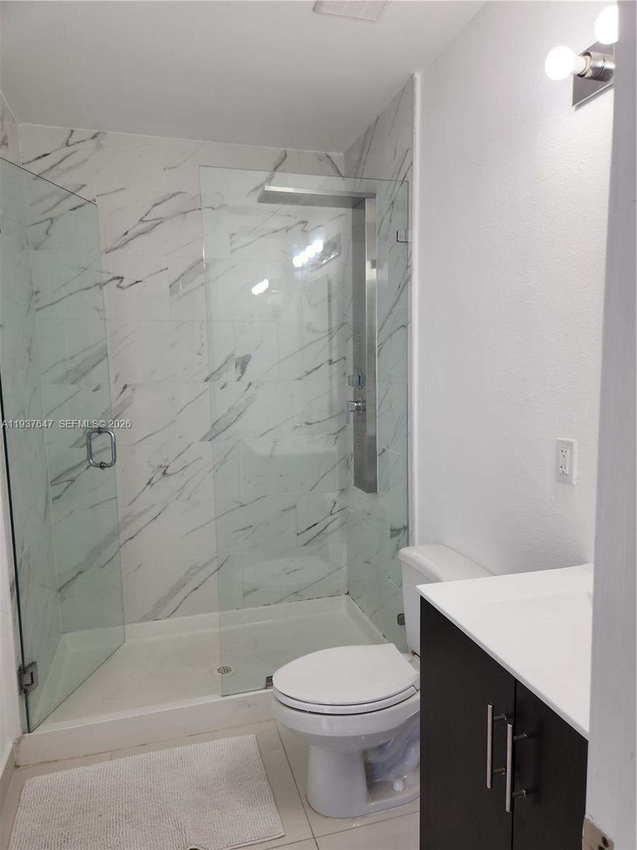 13937 Southwest 259th Street Homestead, FL 33032 - Photo 10 of 17 a bathroom with a bathtub shower sink mirror and toilet