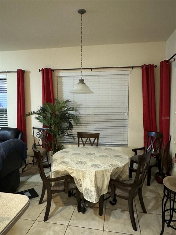 7739 Seafield Lane Wesley Chapel, FL 33545 - Photo 5 of 10 a view of a dining room with furniture and a potted plant