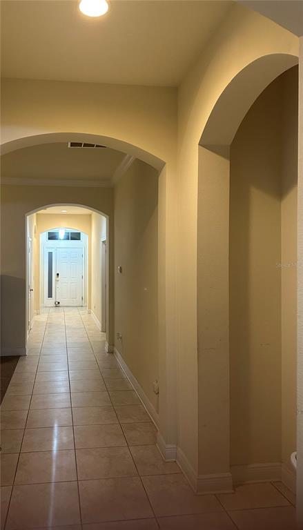 7739 Seafield Lane Wesley Chapel, FL 33545 - Photo 7 of 10 a view of a hallway with wooden floor and a bathroom