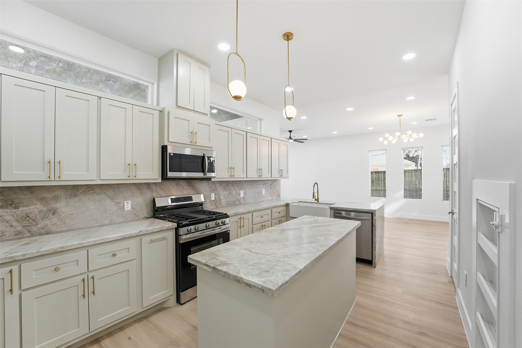 4208 Fox Street Houston, TX 77003 - Photo 12 of 43 a kitchen with stainless steel appliances granite countertop a sink a stove and a refrigerator