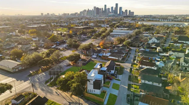 a living room with furniture kitchen view and a flat screen tv