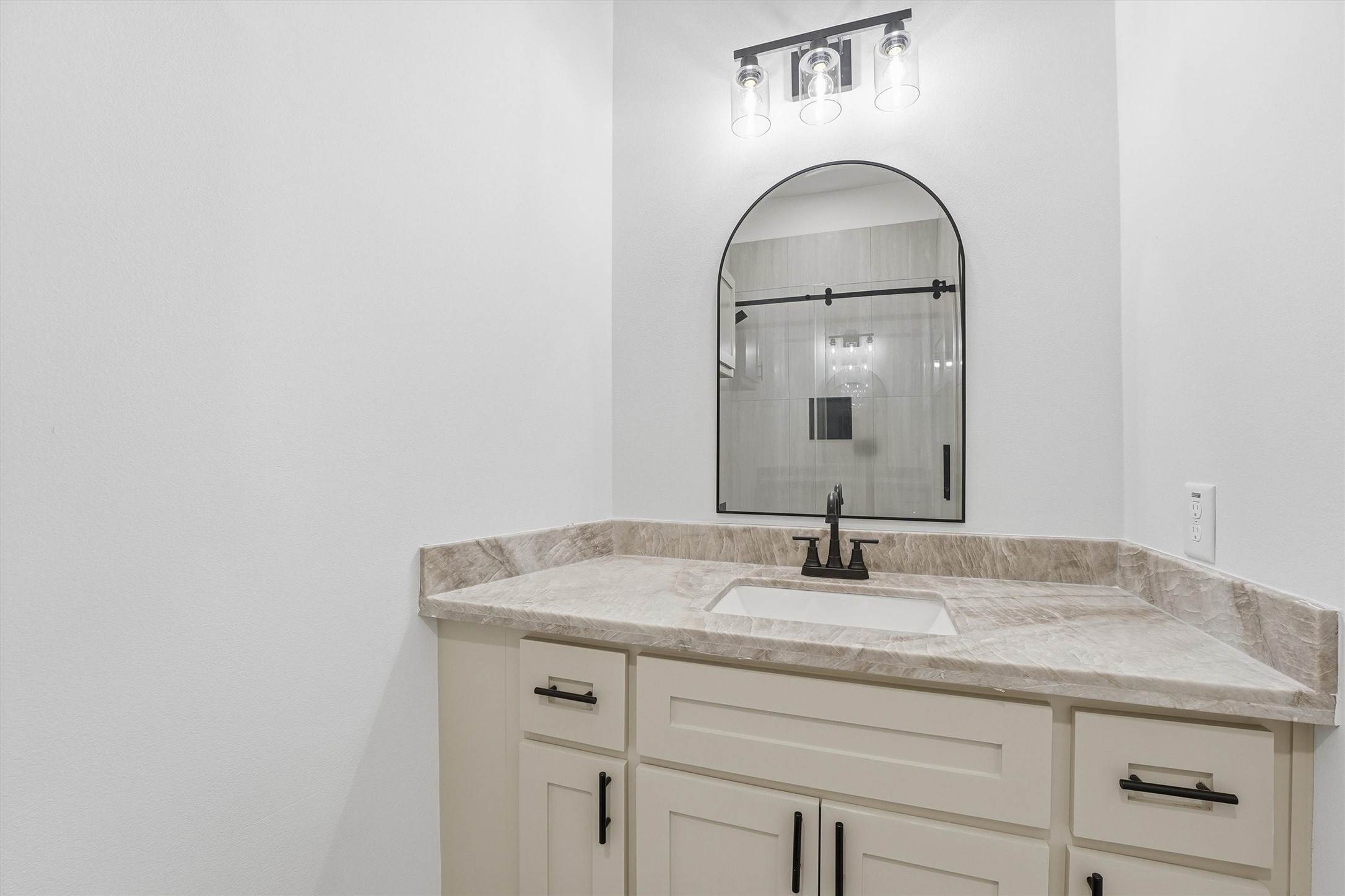 4208 Fox Street Houston, TX 77003 - Photo 25 of 43 a bathroom with a granite countertop sink and a mirror