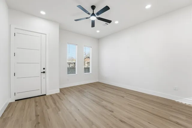 a kitchen with stainless steel appliances granite countertop a sink a stove and a refrigerator