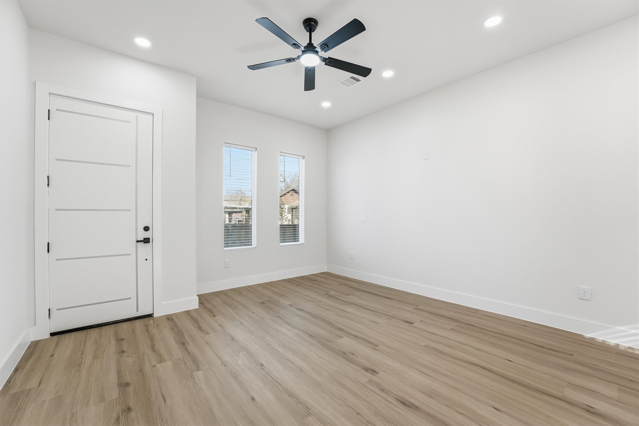 4208 Fox Street Houston, TX 77003 - Photo 6 of 43 wooden floor in an empty room with a window