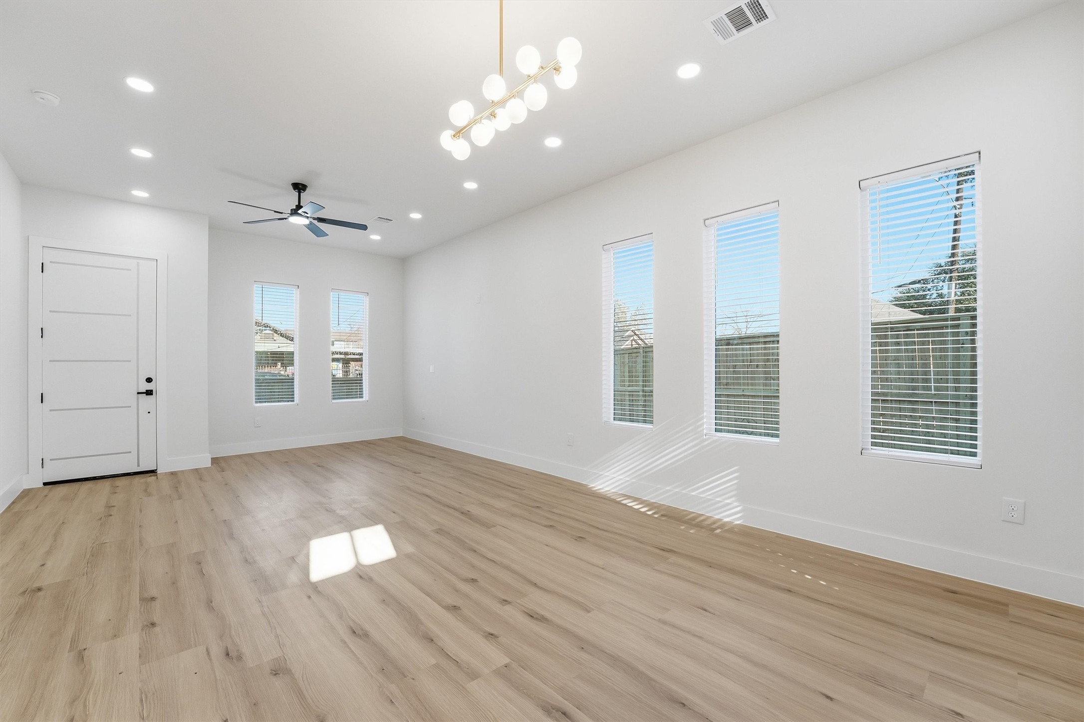4208 Fox Street Houston, TX 77003 - Photo 10 of 43 a view of an empty room with a window and wooden floor