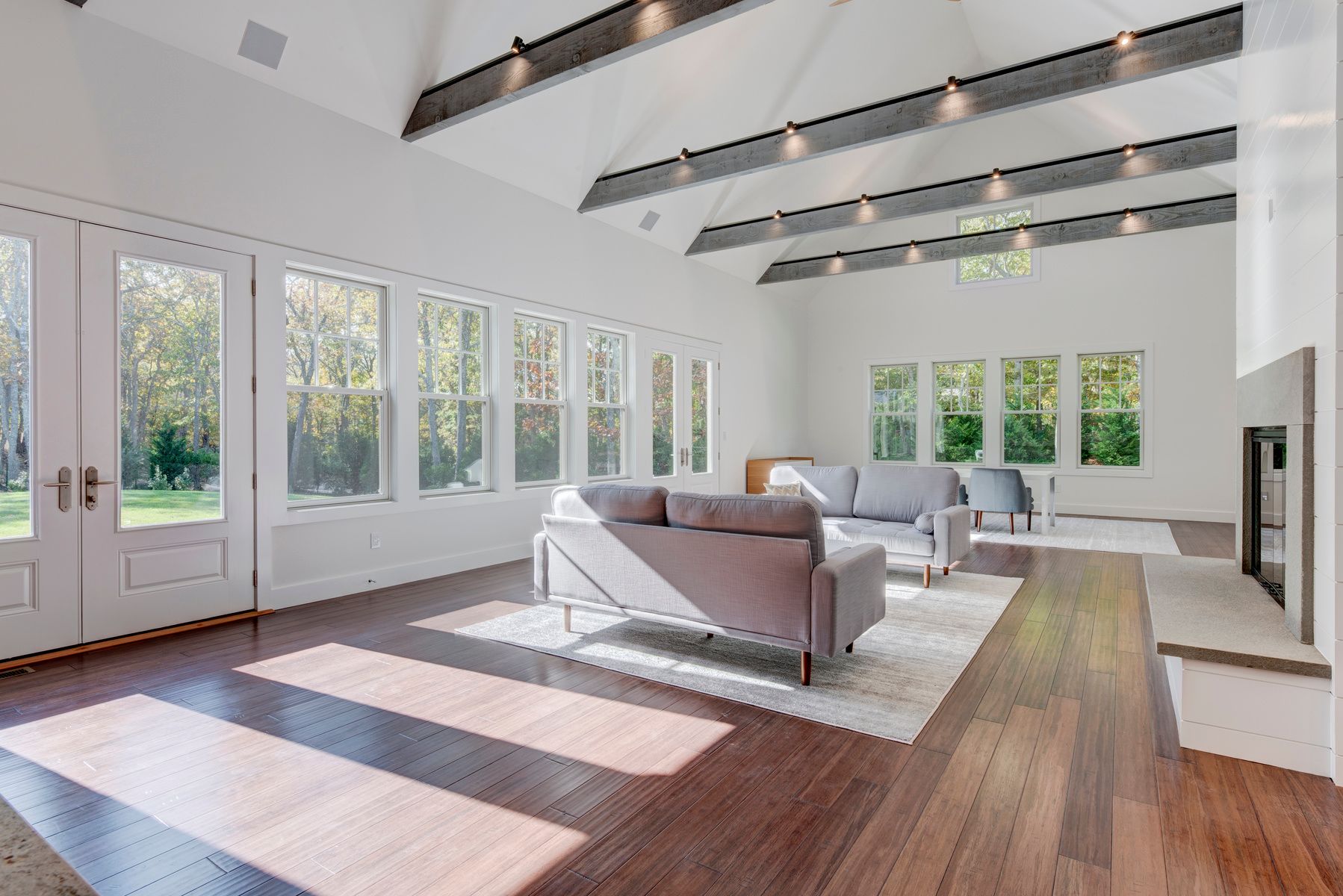 114 Three Mile Harbor Road East Hampton, NY 11937 - Photo 5 of 14 a living room with furniture large windows and wooden floor