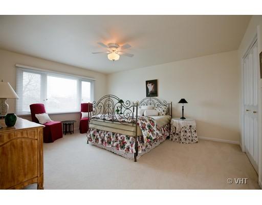 8220 Ridgepoint Drive Burr Ridge, IL 60527 - Photo 13 of 16 a bedroom with furniture and a chandelier