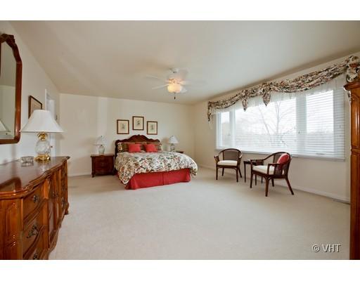 8220 Ridgepoint Drive Burr Ridge, IL 60527 - Photo 9 of 16 a bedroom with furniture and a chandelier