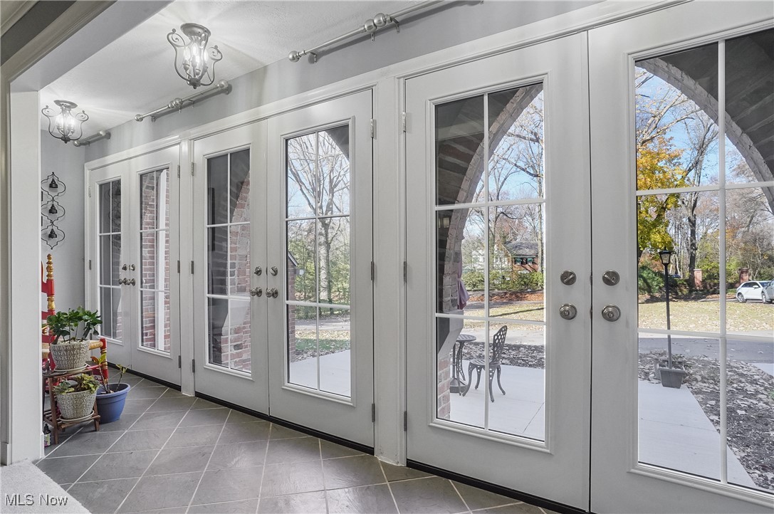 2070 Ridgewood Road Akron, OH 44313 - Photo 10 of 48 Doorway to outside with a wealth of natural light, tile patterned floors, and french doors