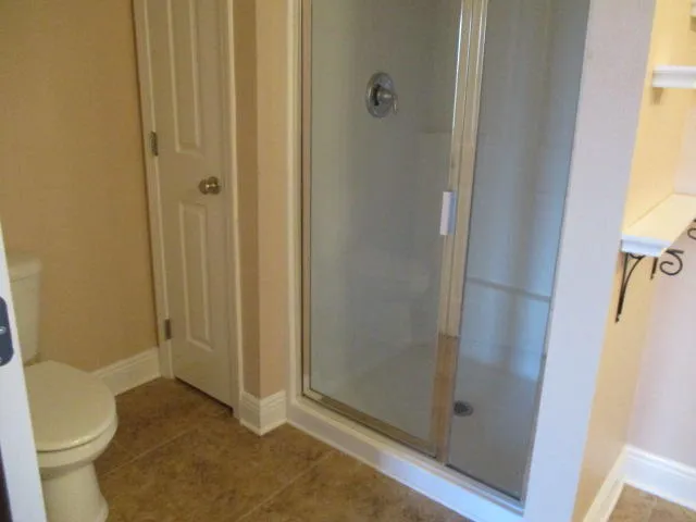 a view of bathroom with a shower and toilet