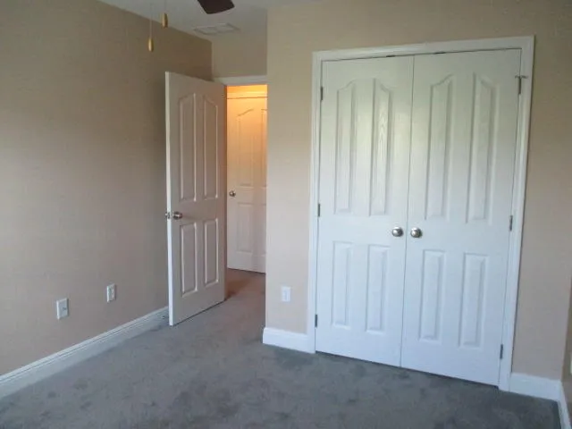 an empty room with closet area