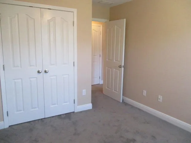 an empty room with a wooden door