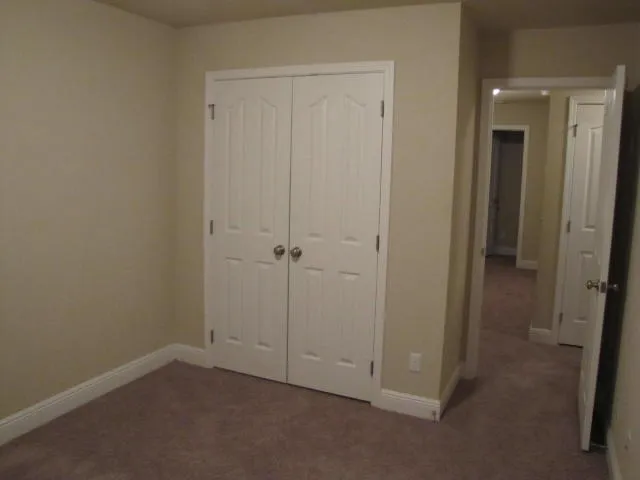 an empty room with closet area
