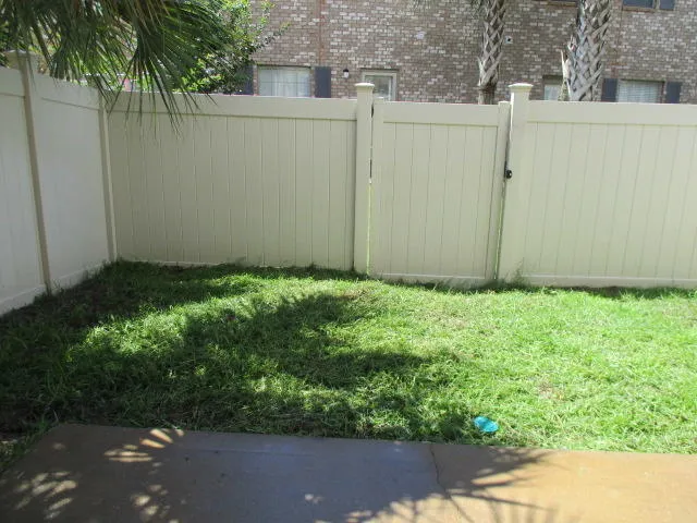 a backyard of a house with lots of green space and plants