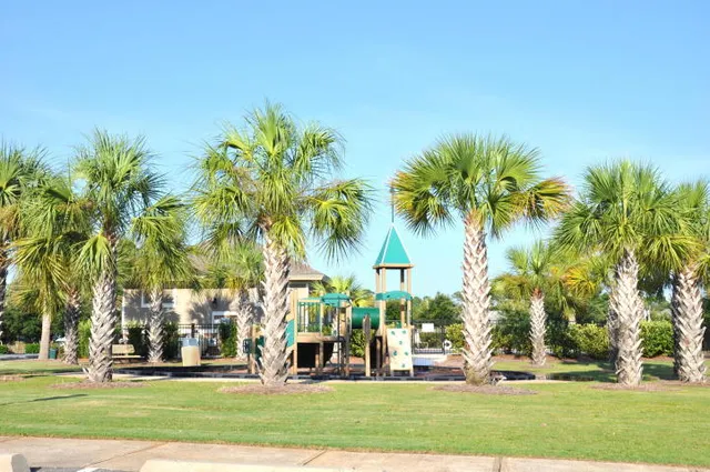 a building exterior with palm trees