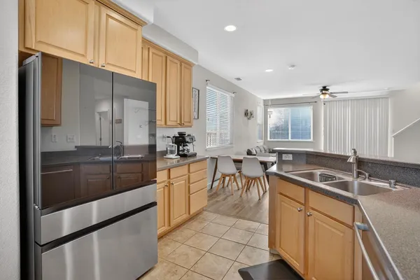 a kitchen with granite countertop a sink stainless steel appliances and cabinets