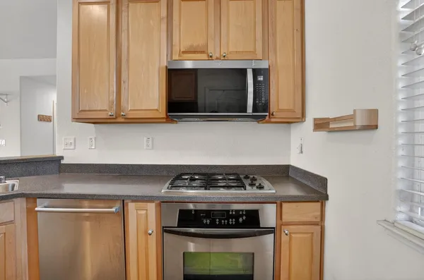 a kitchen with microwave a stove and a sink