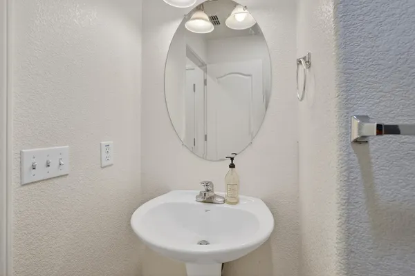 a bathroom with a sink a mirror and shower