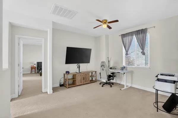 a view of a livingroom with workspace and a window
