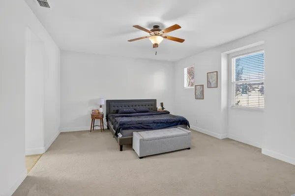 a living room with furniture and a ceiling fan