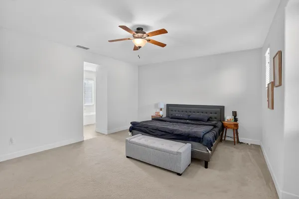 a living room with furniture and a ceiling fan