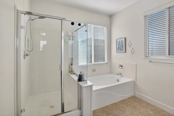 a bathroom with a bathtub and a shower