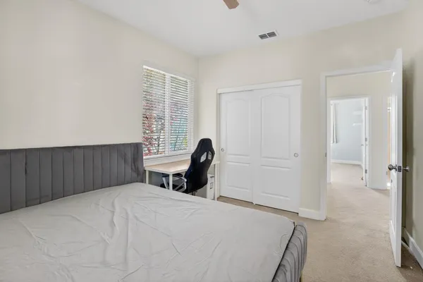 a bedroom with a bed and chair
