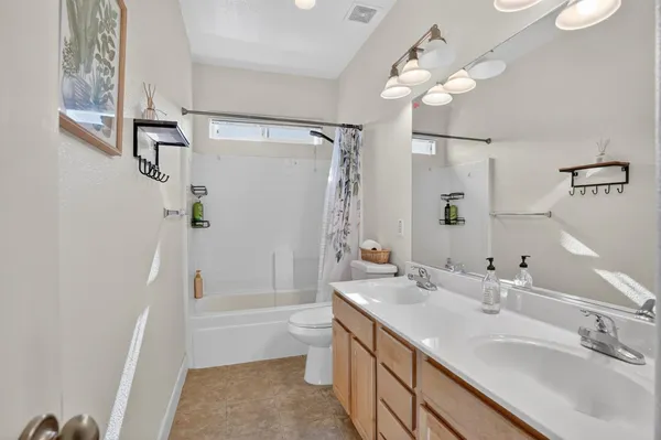 a bathroom with a tub a sink and mirror