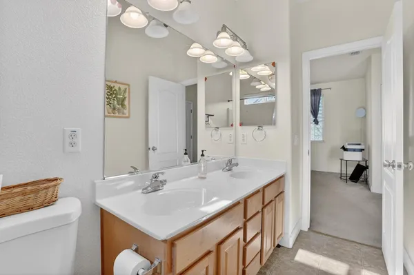 a bathroom with a sink a toilet and a mirror