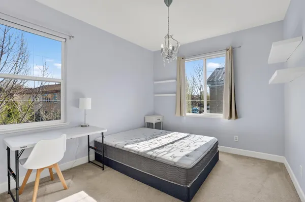 a bedroom with a bed dresser and a window