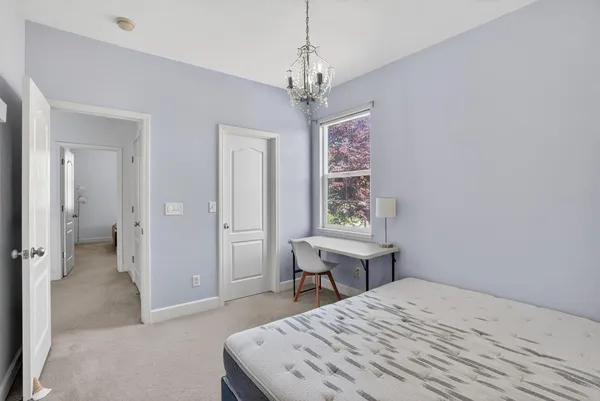 a room that has a bed and a table in it