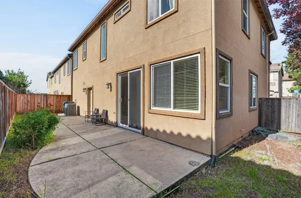 a view of a house with backyard and sitting area