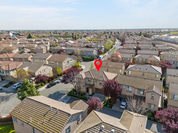 an aerial view of a houses with yard