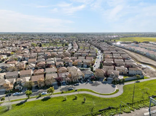 an aerial view of a house with a yard