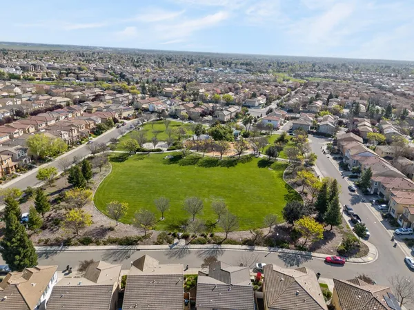 an aerial view of a residential houses with outdoor space