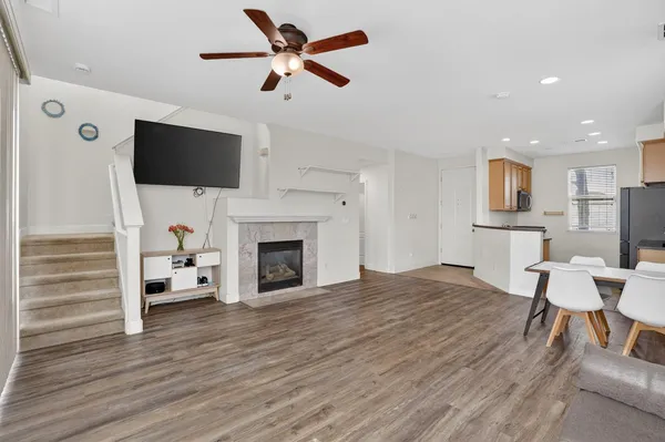 a living room with furniture a fireplace and a flat screen tv