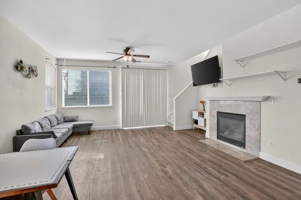 a living room with furniture a flat screen tv and a fireplace