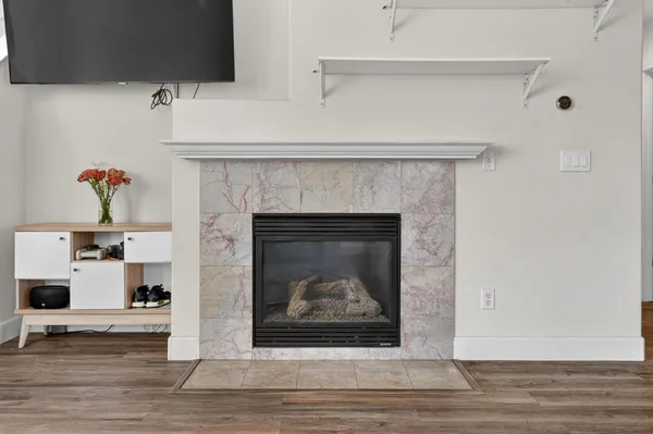 a living room with a fireplace and a fireplace