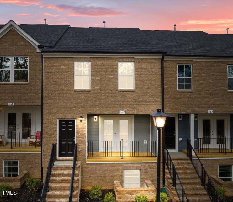 a front view of a house with a lots of windows