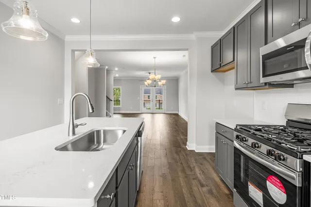 a kitchen with stainless steel appliances a sink a stove and microwave