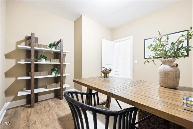 a living room with furniture a rug and white walls