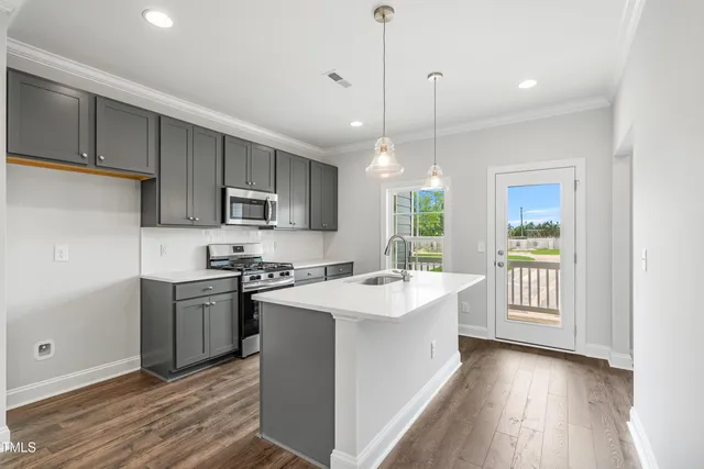 a kitchen with a stove a sink and a refrigerator