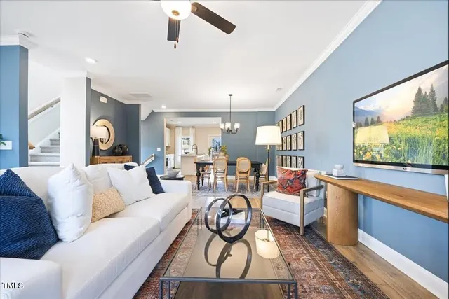 a living room with furniture ceiling fan and a window